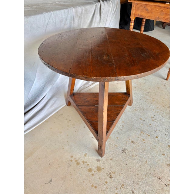 This 19th Century English Pine Cricket Table dates back to the late 1800's. The piece fetures a round planked top resting...