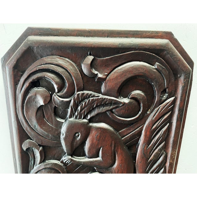 A beautiful, antique relief carving made of solid wood (likely walnut). The piece features a charming and rare motif of a...