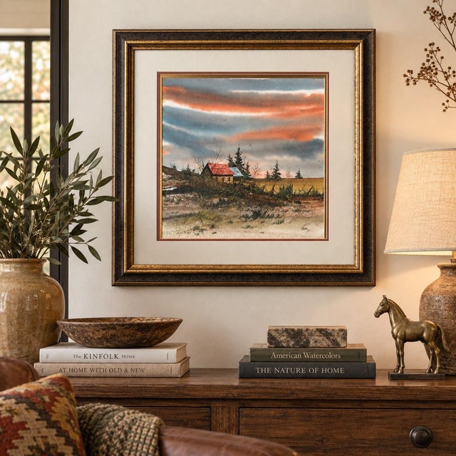 This atmospheric rural landscape depicts a secluded farmhouse or cabin surrounded by evergreens, bare winter trees, rustic...
