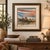 This atmospheric rural landscape depicts a secluded farmhouse or cabin surrounded by evergreens, bare winter trees, rustic...