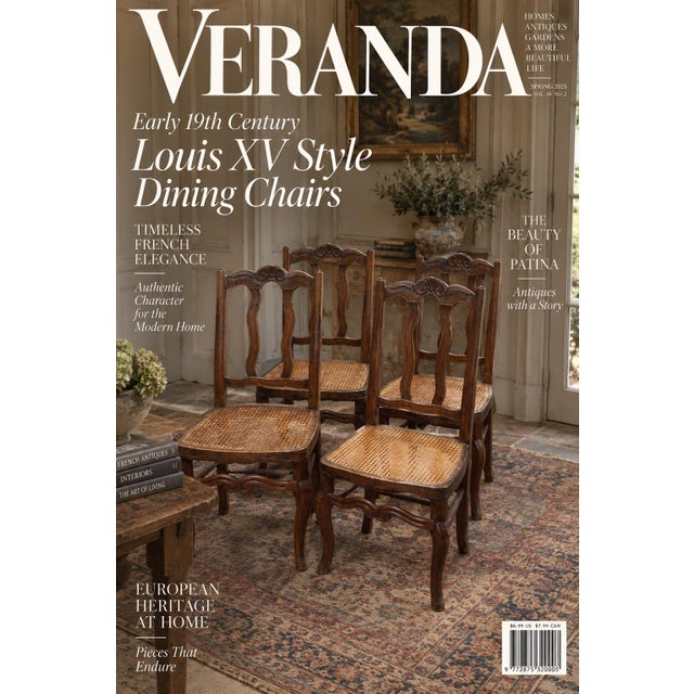 A set of four French provincial dining chairs featuring carved wooden frames with curved crest rails centering a shell...