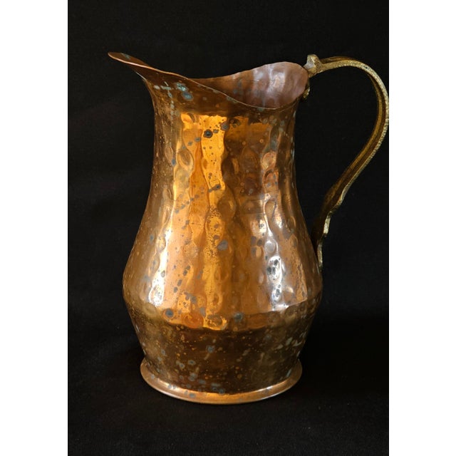 Bring authentic European charm to your space with this vintage French hammered copper pitcher featuring a solid brass...