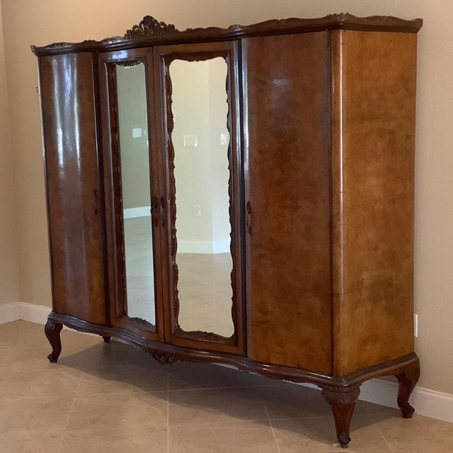 Antique French 4 door armoire. Maple interior, solid wood shelves, wonderful carvings and attention to detail. Full burl...