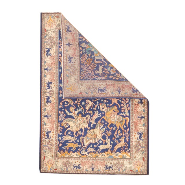 Hand-knotted Persian Isfahan rug, vintage. Woven in wool. The rug depicts a hunting scene with mounted figures, animals,...