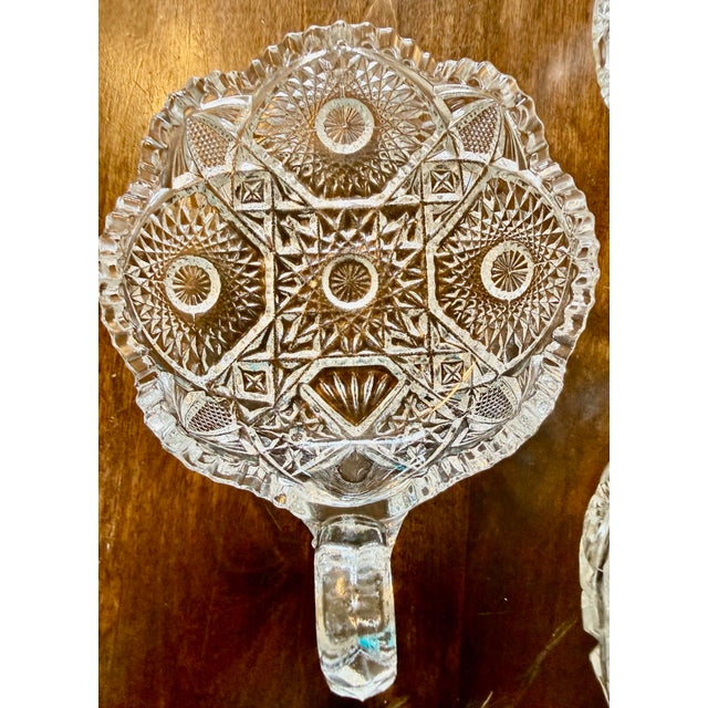 This is a collection of three antique clear glass bowls commonly known as ‘Nappy’ dishes. These small decorative bowls...