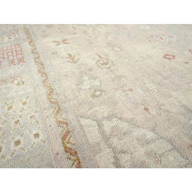 an early 20th century Pastel Antique Oushak Rug