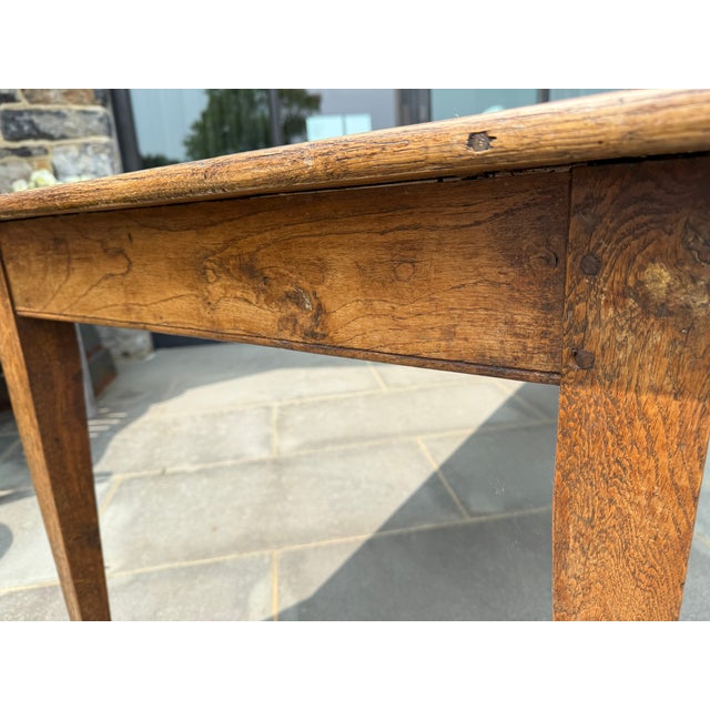 Lovely old French oak dining table. Beautiful patina on the 4 plank top with tapered legs. A few scratches and dings...