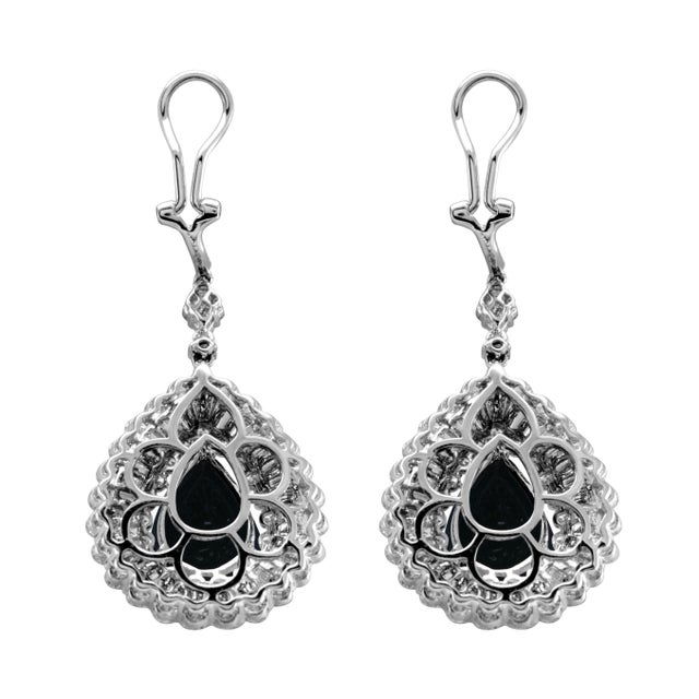Beautiful natural oval emerald and diamonds drop earrings. 17.05 carats total gemstone weight. 2 pear emeralds, 10.08...