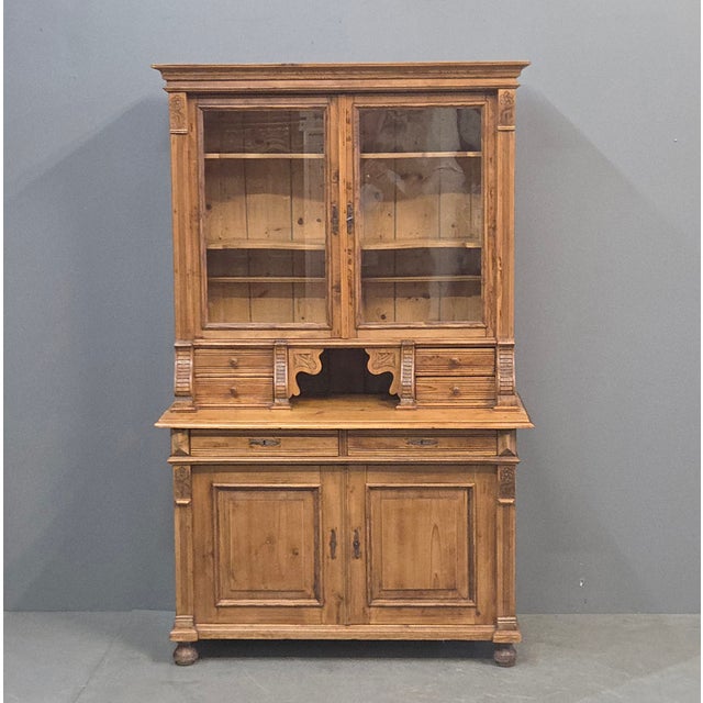 A classic antique early 1900s Eastern European, perhaps German, pine stepback 2-piece cabinet that would be perfect in a...