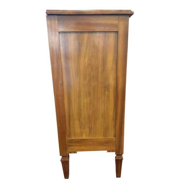 A lovely three-drawer chest in the Louis XVI style. It features a warm honey- toned finish and nice figured grain on the...
