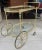 Exceptional brass bar cart. Impress your guests with this sleek brass bar cart with holders for three bottles of your...