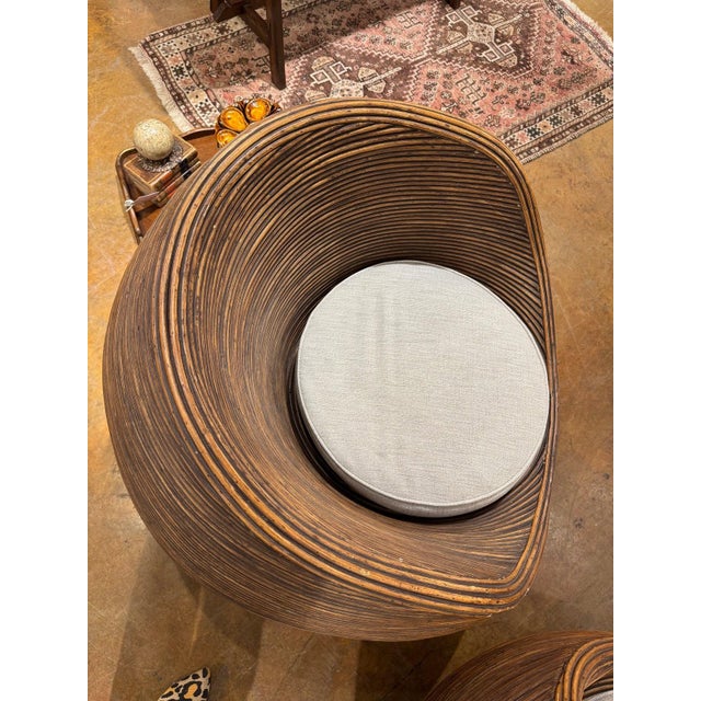 Pair of French mid century split reed chairs and table. Newly upholstered seats. Chairs 34”dia x 31”h Table 27”dia x 18”h...