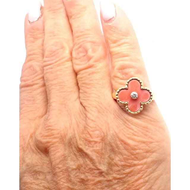 Van Cleef & Arpels Alhambra 18k Yellow Gold Coral Diamond Ring. This ring comes with service paper from a VCA store and a...