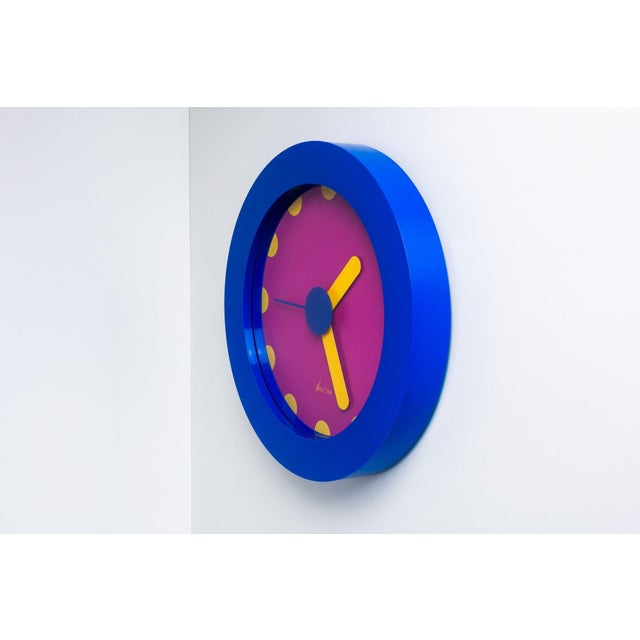Neos Lorenz du Pasquier & Sowden Postmodern Clock A blue and purple plastic postmodern wall clock with yellow hands and...