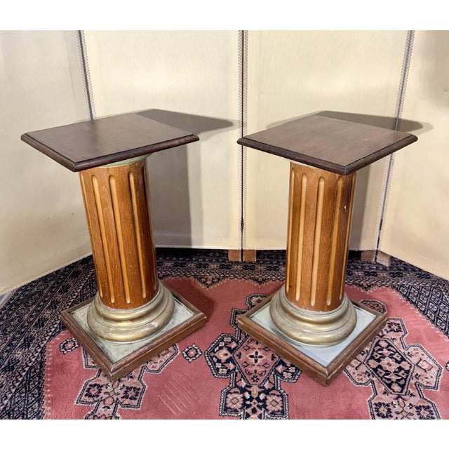 Pair of antique-style columns in solid wood and gilding fluted bodies wooden bands with a gilt patina