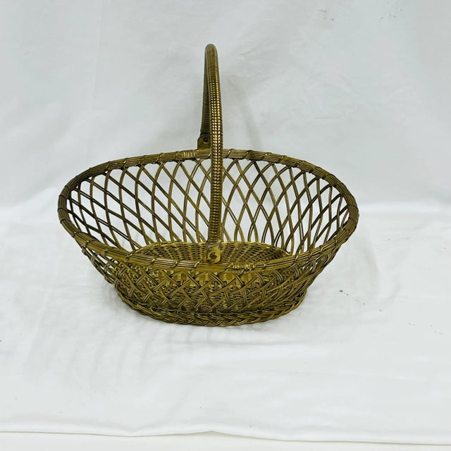 Mid Century hand woven brass basket. Marked Waccamaw, India. Measures 12” w x 10” d x 11” high.