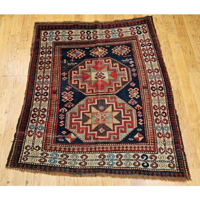 A rare and highly collectible example of 19th century Caucasian weaving, this square-format Kazak area rug from the late...