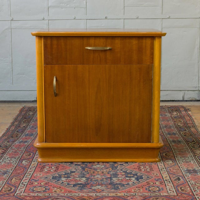 Handsome pair of French Mid-Century mahogany veneered nightstands, each featuring a drawer above a cabinet door fitted...