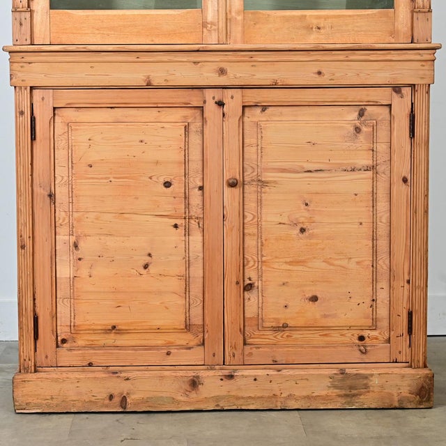 This tall English bookcase is perfect for a slender wall in need of storage and display. The top of the bookcase is...