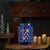 Bring the cozy charm of winter indoors with this 9.5" snowflake punched metal candle lantern. Finished in a rich navy blue...