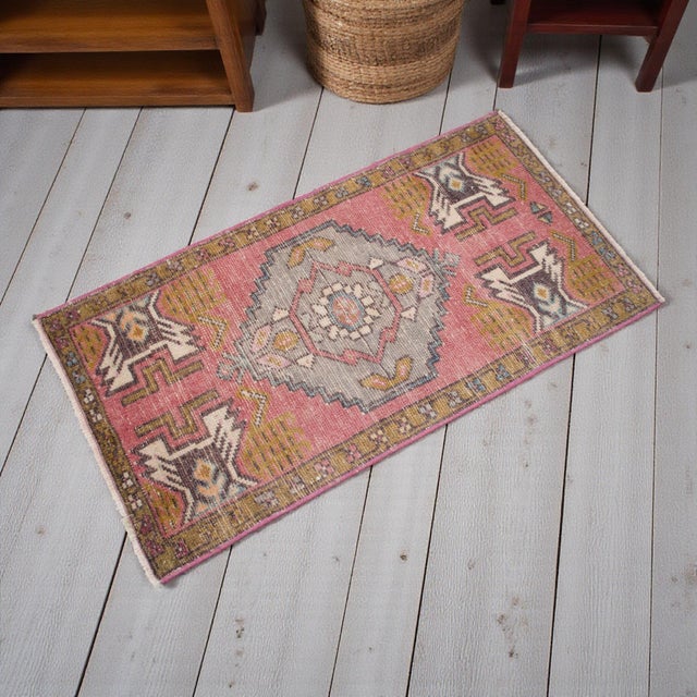 This exquisite vintage Oushak mat from the 1970s brings a touch of Anatolian heritage to any cozy corner of your home....
