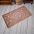This exquisite vintage Oushak mat from the 1970s brings a touch of Anatolian heritage to any cozy corner of your home....