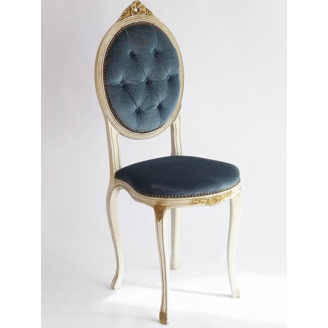 Wooden chair made in France in the style of Louis XV. The skeleton is painted in white along with golden floral details....