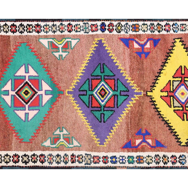 This Vintage Turkish Oushak Runner, measuring 2'10" x 12'2", is handwoven with wool on a wool foundation in the Oushak...