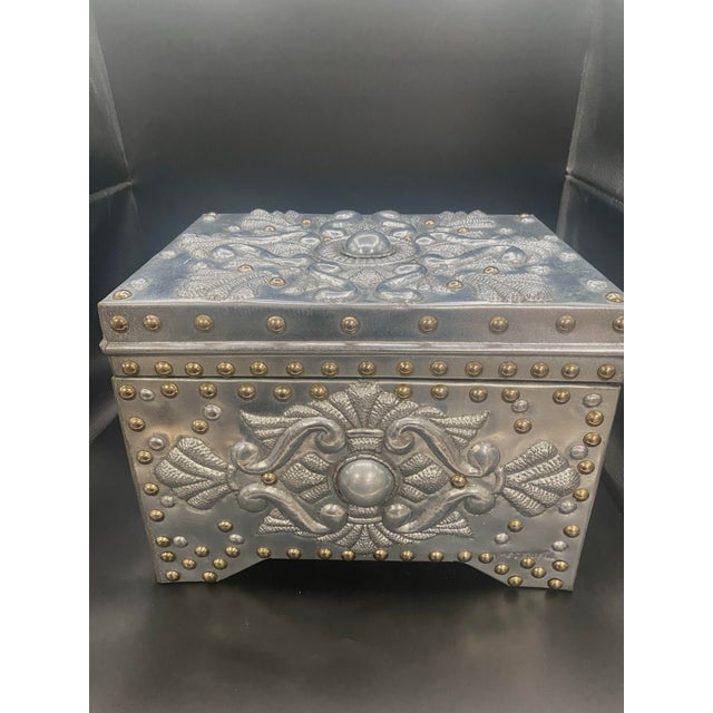 Handsome hand crafted and signed repousse steel cedar lined hinged box. The box measures 12” long x 9” high. It is lined...