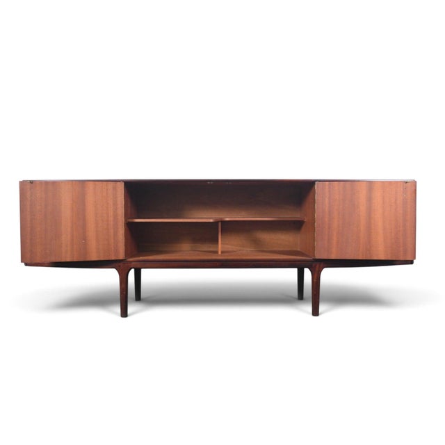 This "Dunotter" credenza was designed by Val Rossi and produced by A.H. McIntosh in Scotland during the 1960s. The...