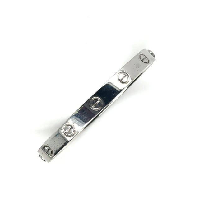 Cartier Love Bracelet in 18k White Gold: This bracelet features an oval shape. It's characterized by its screw designs and...