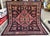 Persian Shiraz tribal kilim featuring a bold hexagonal medallion in salmon pink with intricate floral lattice and a soft...
