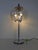 Chrome-plated table lamp with a large, round glass shade. Three lights. Mirrored light bulbs are included. The chrome...