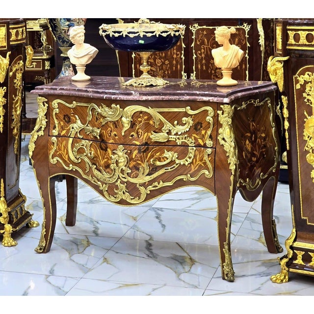 A true masterpiece of French-inspired luxury, this stunning Louis XV Bombe Commode showcases an elegant serpentine...
