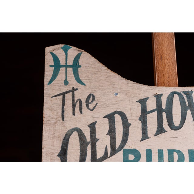 Hand-painted wooden advertising sign for "The Old Howard Burlesque at Scollay Sq." featuring stylized black and teal...