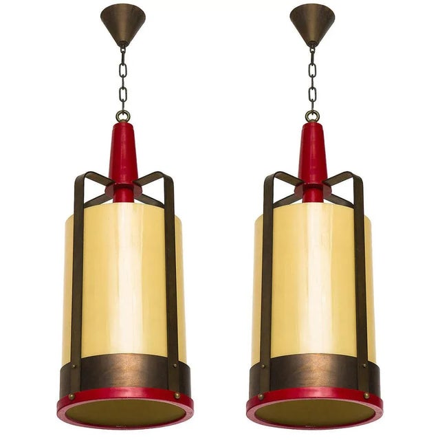 Large industrial style lantern style pendants with amber glass diffusers.