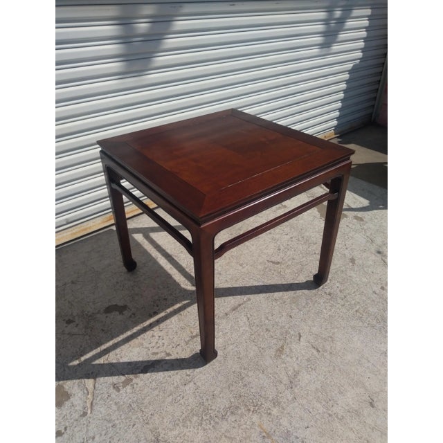 This Henredon side table is made of solid walnut. It's made in the chinoiserie ming style. It has hoofed feet and humpback...
