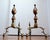 An antique pair of classic American brass and iron lemon-top andirons create a beautiful silhouette in front of a cozy...