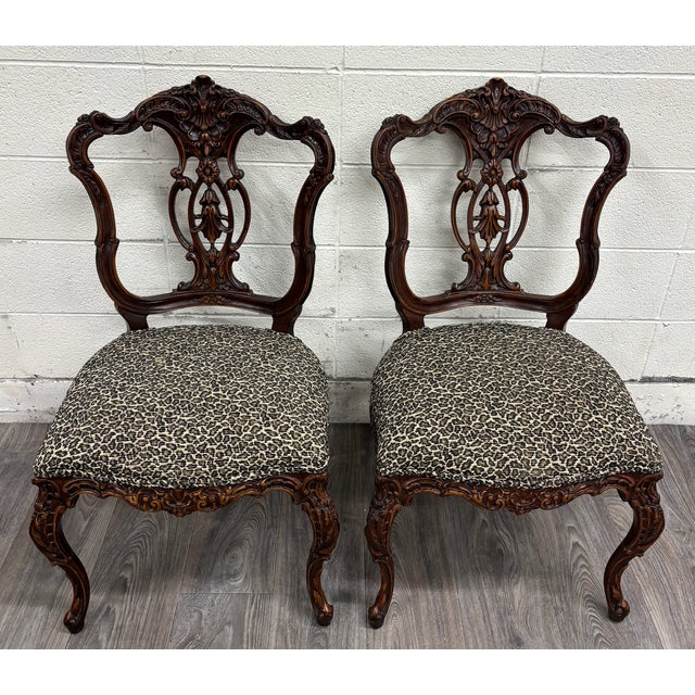 This is a stunning pair of antique late 19th-century French Rococo Revival side chairs, crafted in solid walnut with...