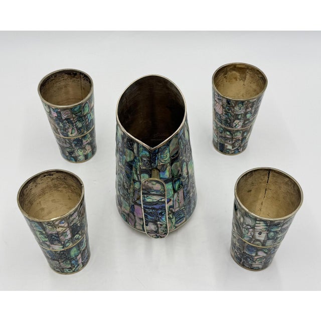 Exceptional 1960s Mexican Modernist barware set comprising a large water or beverage pitcher and four matching tumblers,...