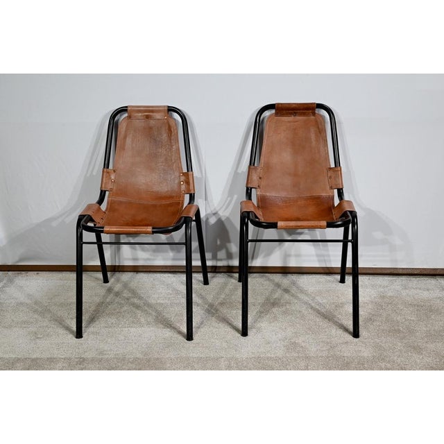 Pair of chairs according to the work of Charlotte Perriand (1903-1999) for the Savoyard ski resort. Perriand is a French...