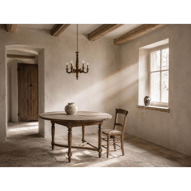 French neoclassical-style five-light chandelier, hand-carved from wood circa 1950 and finished in an aged gold tone. The...