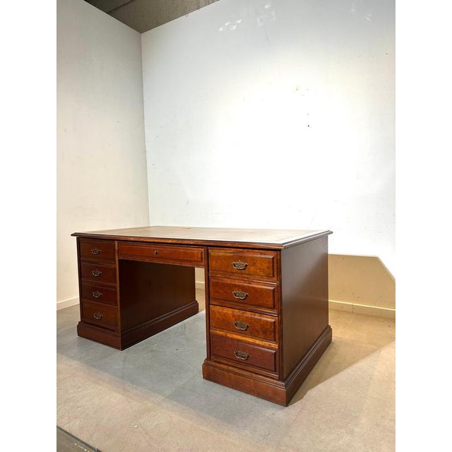 Elegant and substantial classic executive desk, crafted in richly finished wood and featuring a refined leather-inlay...