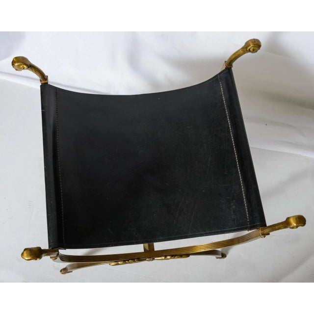 Great looking, French Curule Bronze Ram Heads & Black Leather Stool Attributed to Maison Jansen. This curule Stool is a...