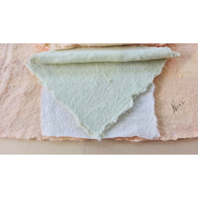 A matched pair of handmade paper relief sculptures, dated September 1987. Layered and pleated paper in blush salmon,...