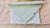 A matched pair of handmade paper relief sculptures, dated September 1987. Layered and pleated paper in blush salmon,...