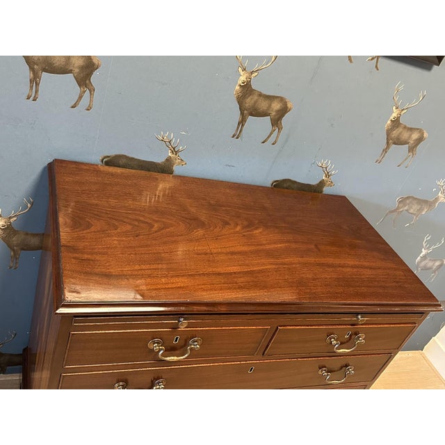 A beautiful, small antique mahogany chest of drawers in perfect condition. The piece features three large drawers and two...