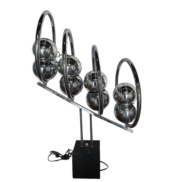 Amazing 1970.s Quadruple Chrome Eyeball Lamp sold as found previously used in decent shape showing minor nicks to wood base.