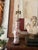 An elegant vintage chinoiserie table lamp featuring a warm cinnamon and white palette with delicate peach and gold...