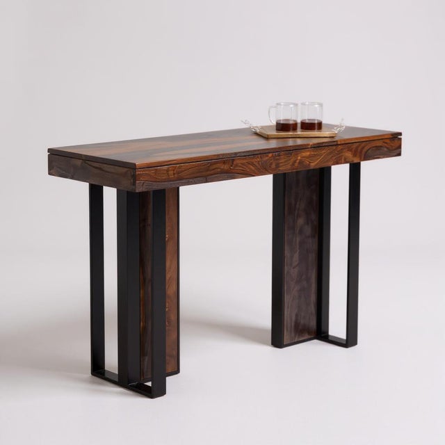 Enhance your living space with a blend of rustic charm and industrial flair with this wooden console table by LOOMLAN....